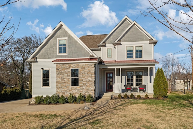 craftsman-style house featuring a front yard and covered porch