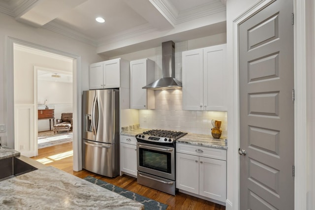 kitchen with appliances with stainless steel finishes, white cabinetry, light stone countertops, dark hardwood / wood-style flooring, and wall chimney exhaust hood