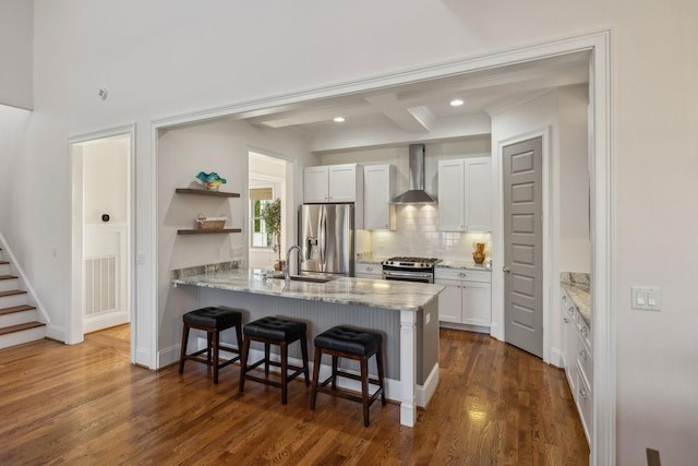 kitchen featuring white cabinets, sink, wall chimney exhaust hood, and appliances with stainless steel finishes