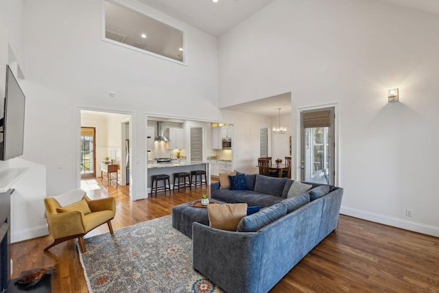 living room featuring a wealth of natural light, dark hardwood / wood-style floors, and a high ceiling