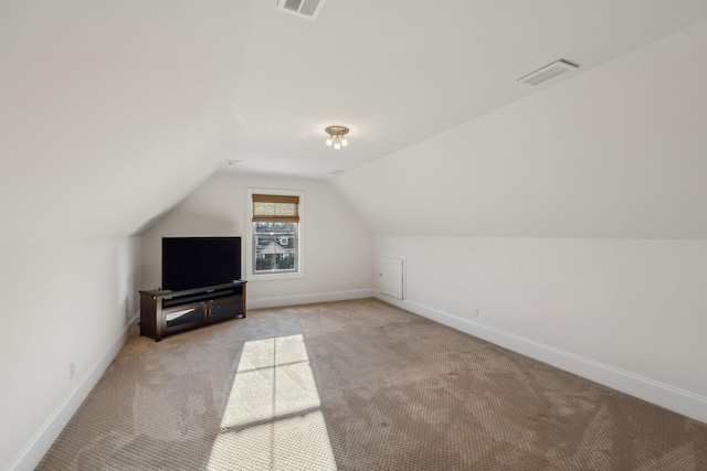 bonus room featuring lofted ceiling and light colored carpet