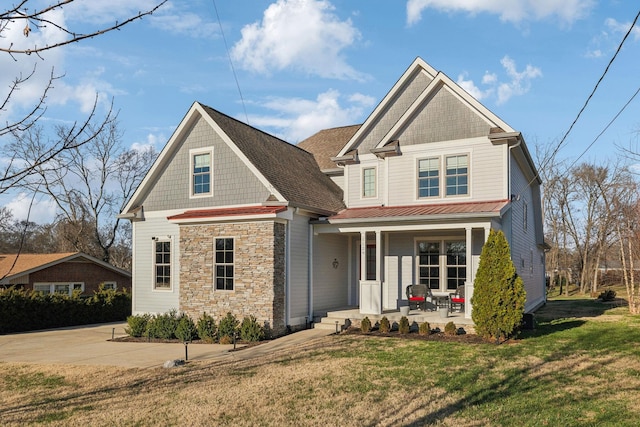 craftsman house with covered porch and a front lawn