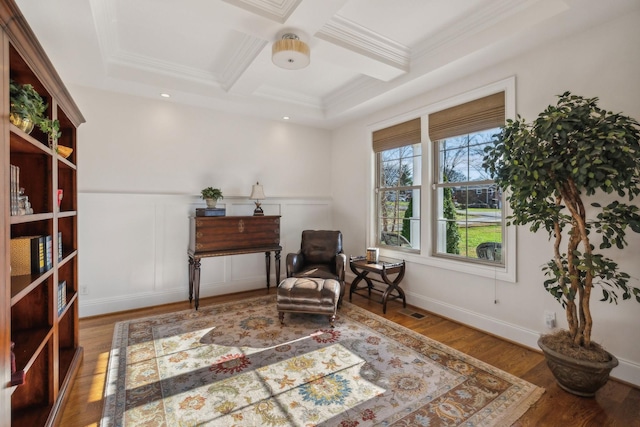 living area with beamed ceiling, crown molding, coffered ceiling, and hardwood / wood-style floors