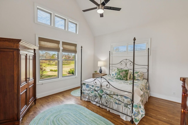 bedroom featuring wood-type flooring, high vaulted ceiling, and ceiling fan