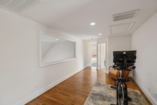 exercise room with hardwood / wood-style flooring