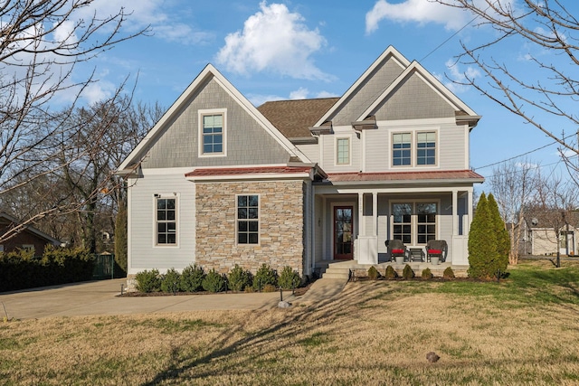 craftsman-style home with a front lawn and covered porch