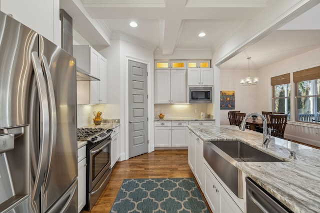 kitchen featuring white cabinetry, appliances with stainless steel finishes, beam ceiling, and tasteful backsplash