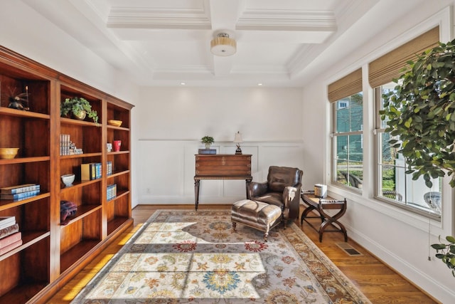 living area featuring crown molding, coffered ceiling, beam ceiling, and light wood-type flooring