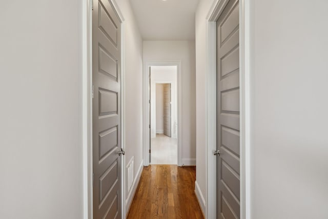 hallway with dark hardwood / wood-style floors