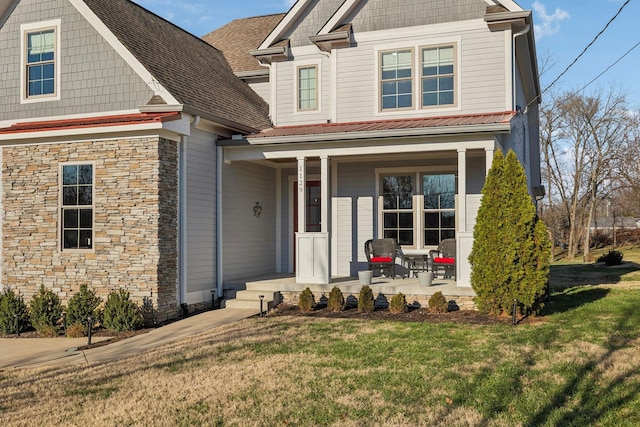 view of front of house featuring a front lawn and covered porch