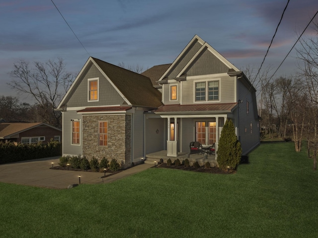 view of front of property with a lawn and a porch