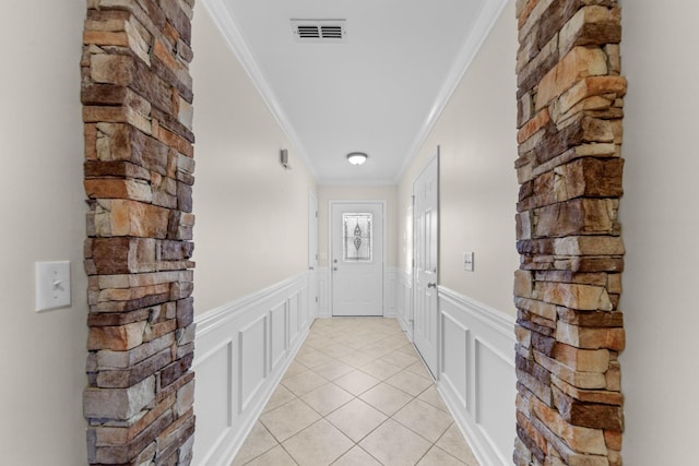 doorway to outside featuring ornamental molding and light tile patterned flooring