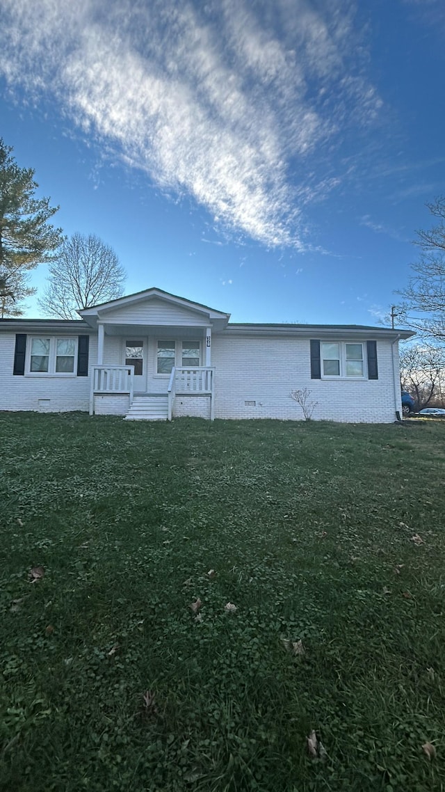 single story home featuring covered porch and a front lawn