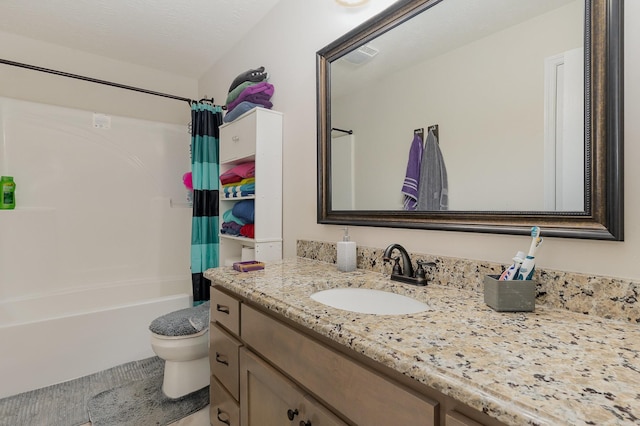 bathroom featuring shower / bath combination with curtain, vanity, toilet, and a textured ceiling