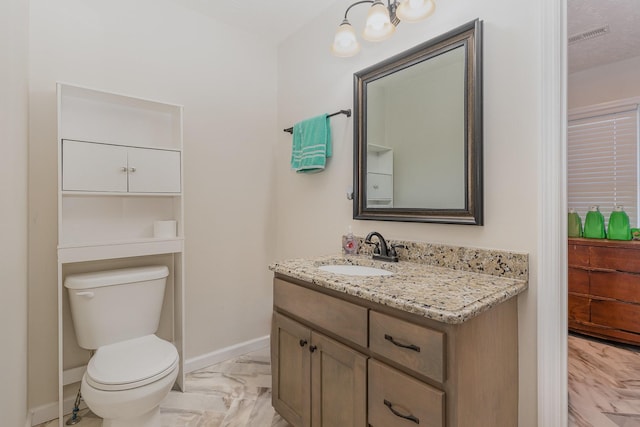 half bathroom with marble finish floor, baseboards, vanity, and toilet