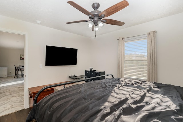 bedroom featuring a ceiling fan and wood finished floors