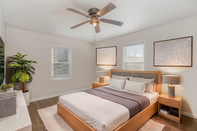 bedroom with wood finished floors, a ceiling fan, and baseboards