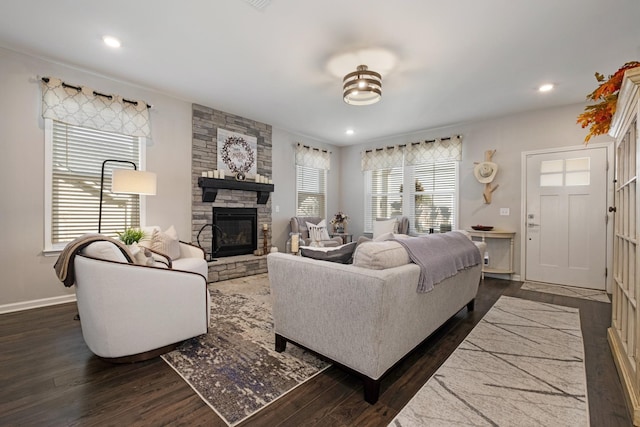 living room featuring a stone fireplace and dark hardwood / wood-style floors