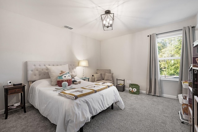 bedroom featuring a chandelier, carpet floors, and multiple windows