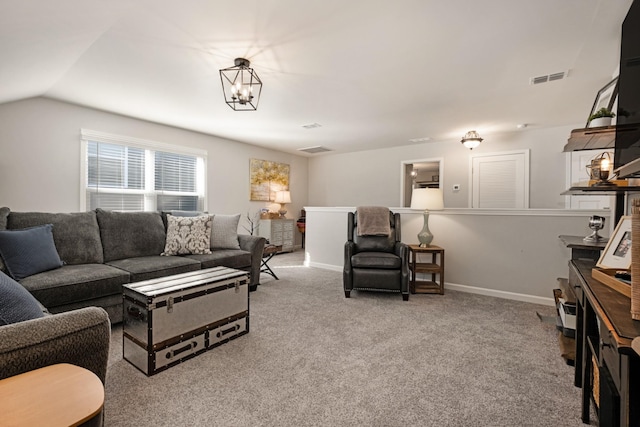 carpeted living room featuring an inviting chandelier and vaulted ceiling