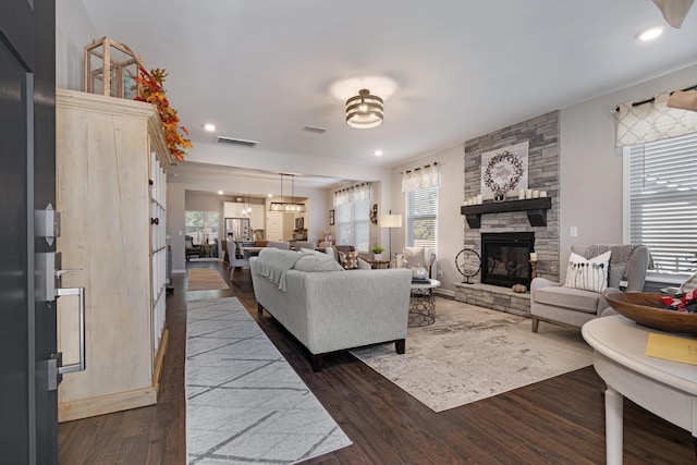 living room with a fireplace and dark wood-type flooring