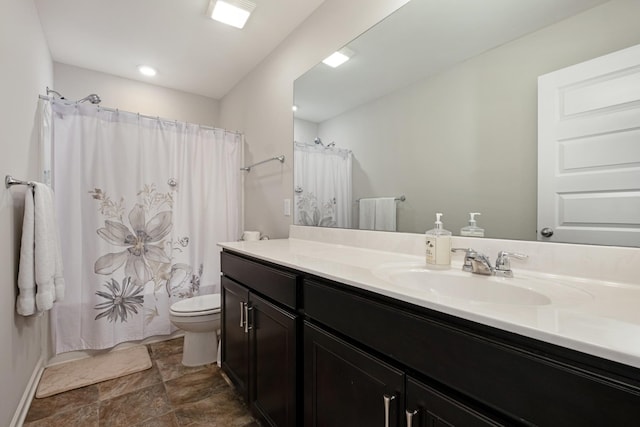 bathroom with vanity, toilet, and walk in shower