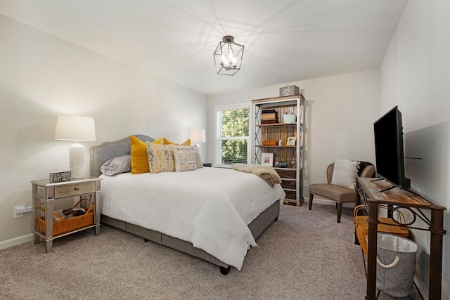 bedroom featuring carpet floors and a notable chandelier