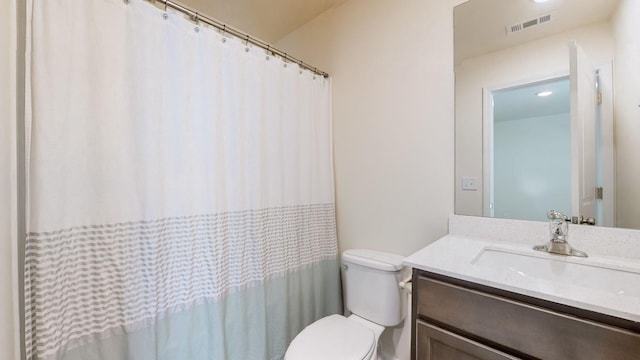 bathroom featuring vanity and toilet