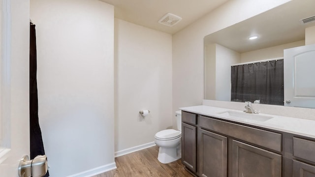 bathroom featuring hardwood / wood-style floors, vanity, and toilet