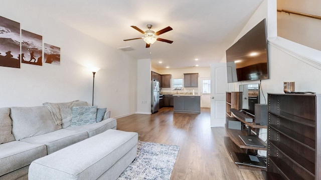 living room with hardwood / wood-style flooring and ceiling fan