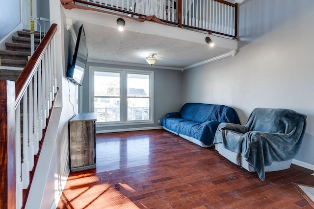 living room featuring a textured ceiling, crown molding, and dark hardwood / wood-style floors