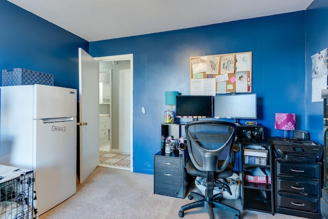 office with carpet and a textured ceiling