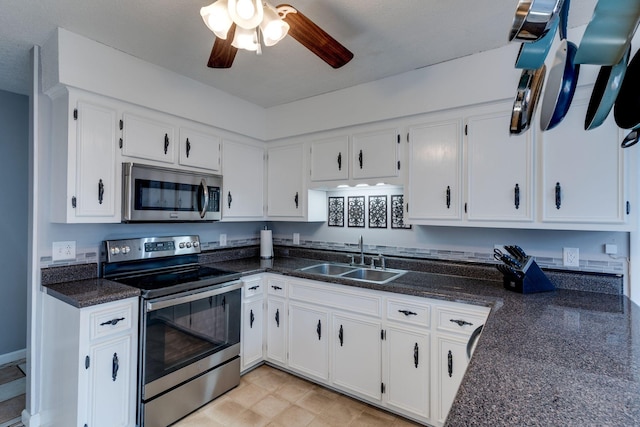 kitchen featuring white cabinets, sink, ceiling fan, light tile patterned floors, and appliances with stainless steel finishes