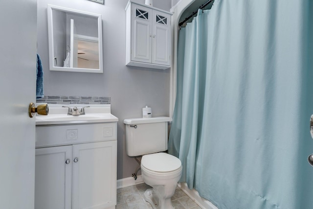 bathroom with tasteful backsplash, vanity, and toilet