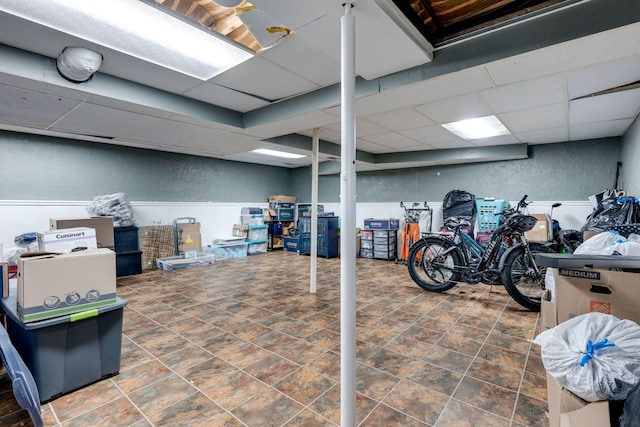 basement with a paneled ceiling