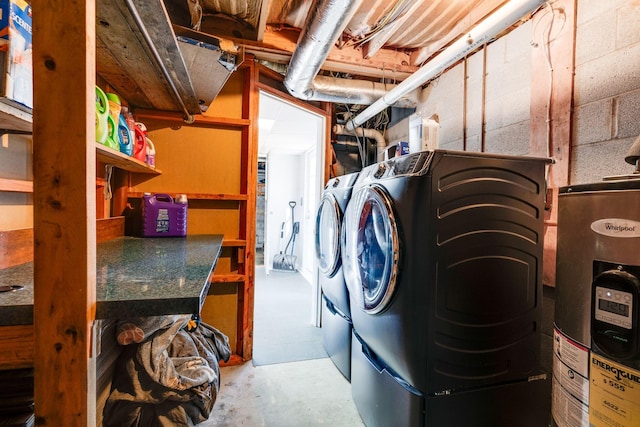 clothes washing area featuring washer and dryer and water heater