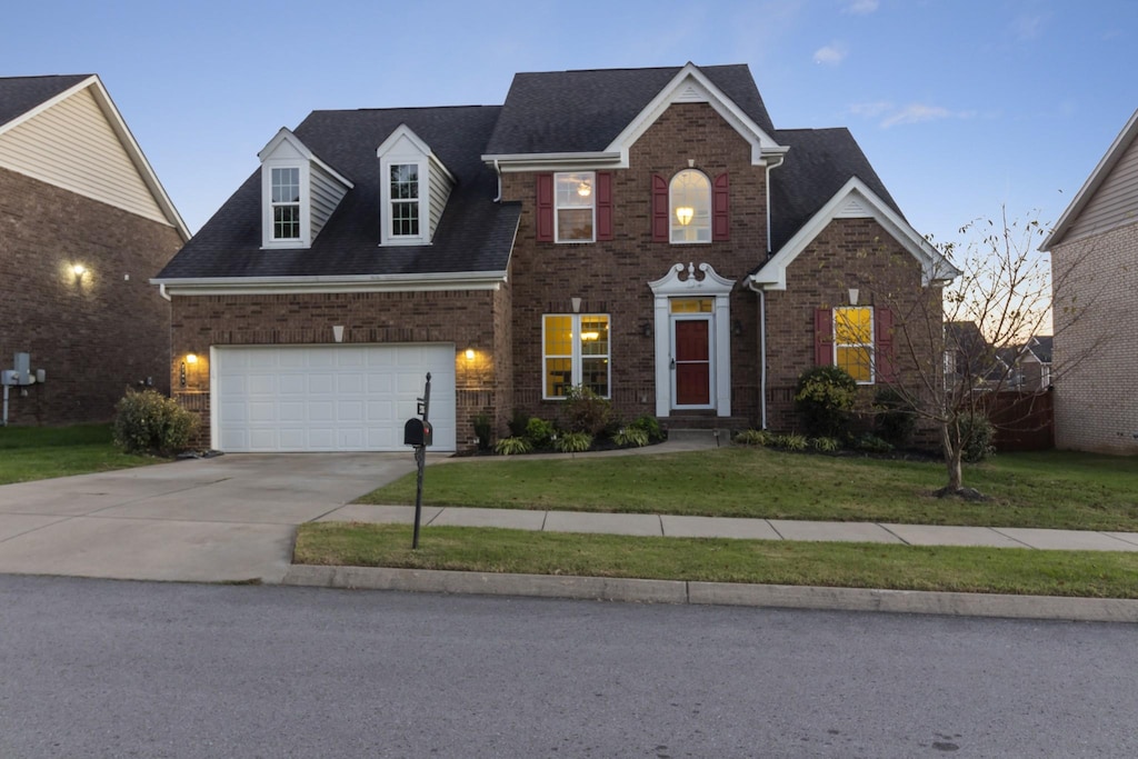 view of front facade featuring a lawn and a garage