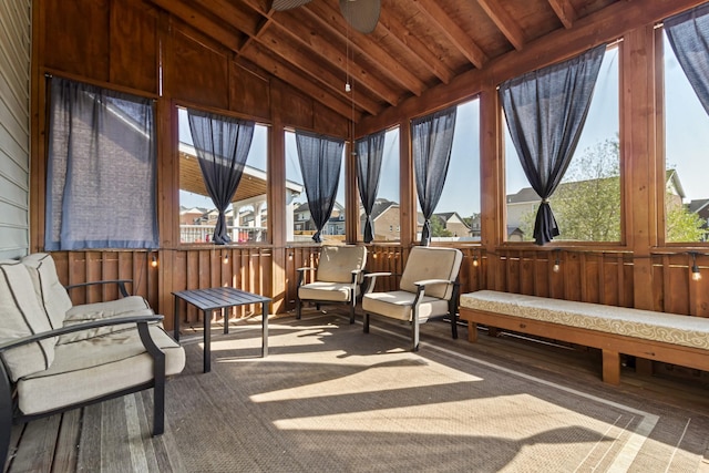 sunroom featuring ceiling fan, plenty of natural light, and lofted ceiling