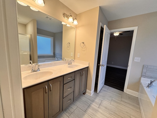 bathroom featuring vanity, separate shower and tub, and ceiling fan