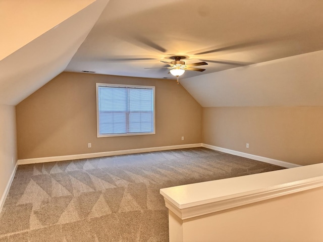 additional living space with ceiling fan, carpet, and lofted ceiling