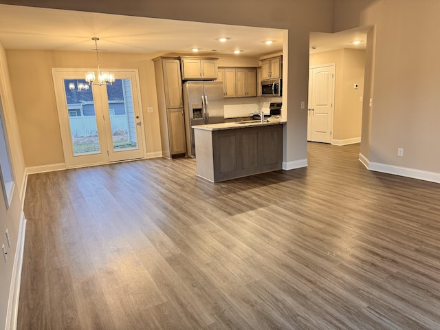 kitchen with sink, stainless steel appliances, hanging light fixtures, dark hardwood / wood-style floors, and a chandelier