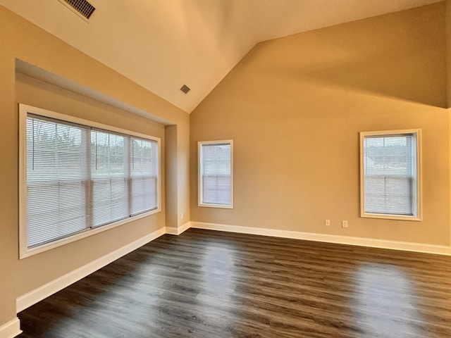 unfurnished room with lofted ceiling and dark wood-type flooring