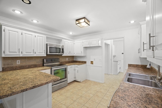 kitchen featuring decorative backsplash, appliances with stainless steel finishes, light tile patterned flooring, a sink, and white cabinetry