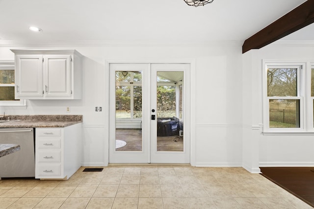 entryway with baseboards, visible vents, crown molding, french doors, and light tile patterned flooring