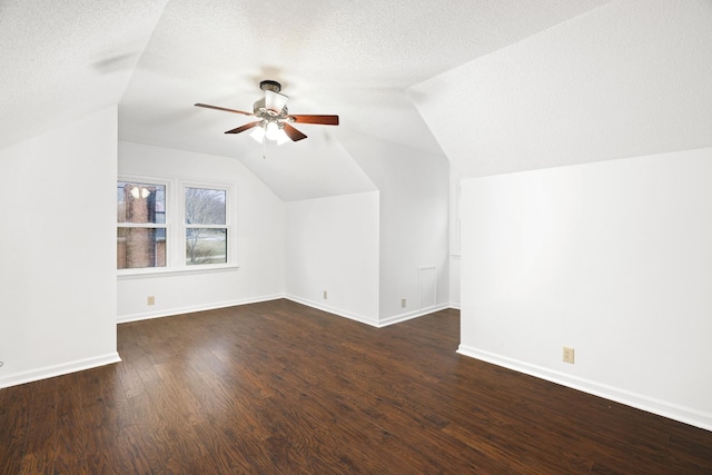 bonus room with lofted ceiling, a textured ceiling, baseboards, and wood finished floors