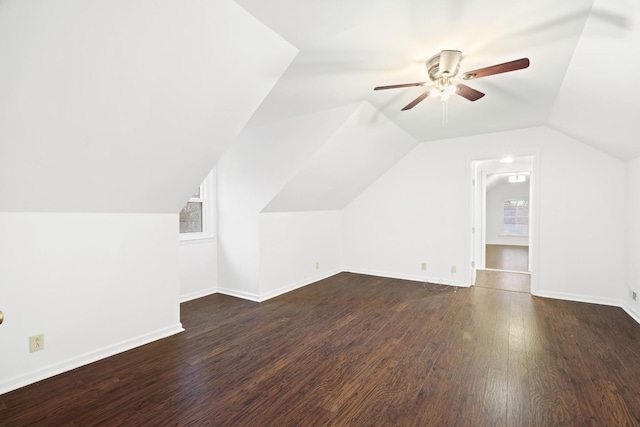 bonus room with vaulted ceiling, ceiling fan, wood finished floors, and baseboards