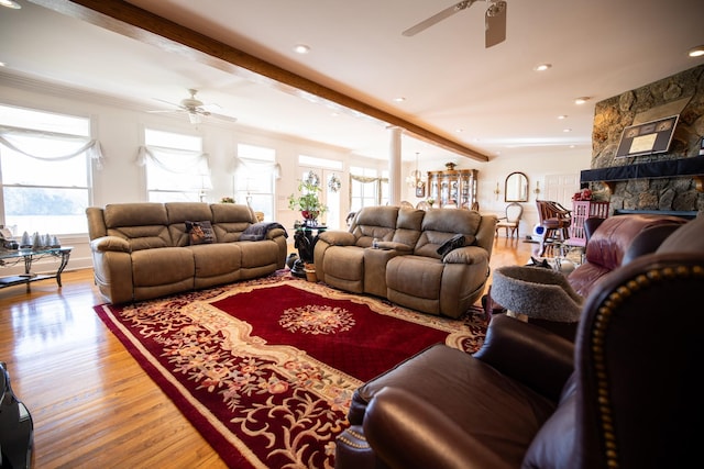 living room featuring beam ceiling, ceiling fan, hardwood / wood-style floors, and plenty of natural light