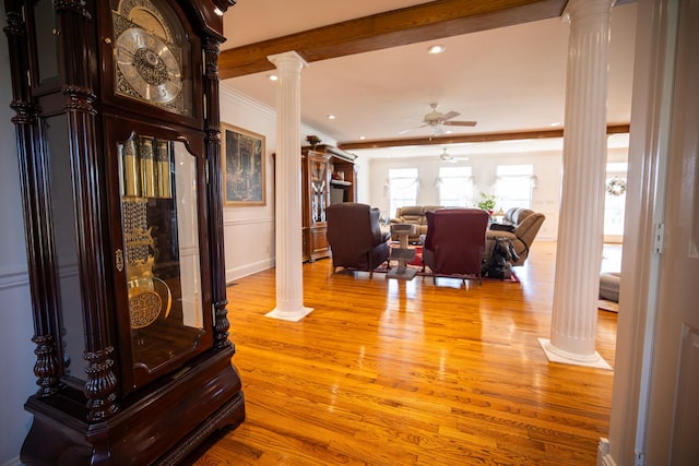 hall with decorative columns, light hardwood / wood-style flooring, and ornamental molding