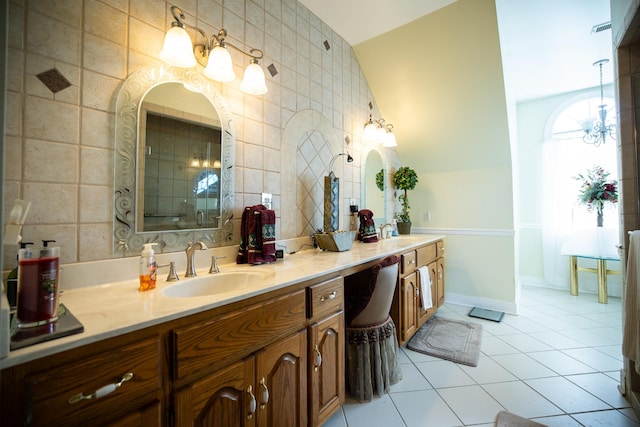 bathroom with a shower with shower door, vanity, tile walls, tile patterned flooring, and lofted ceiling