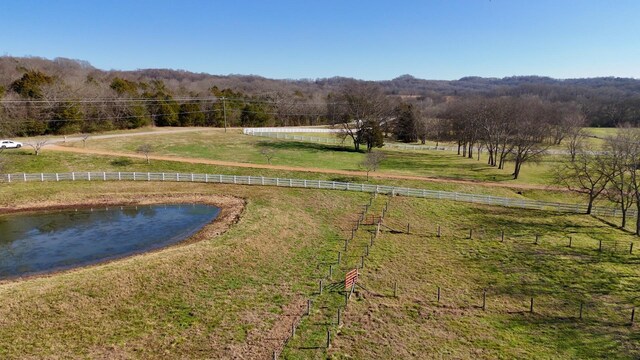 birds eye view of property with a water view and a rural view